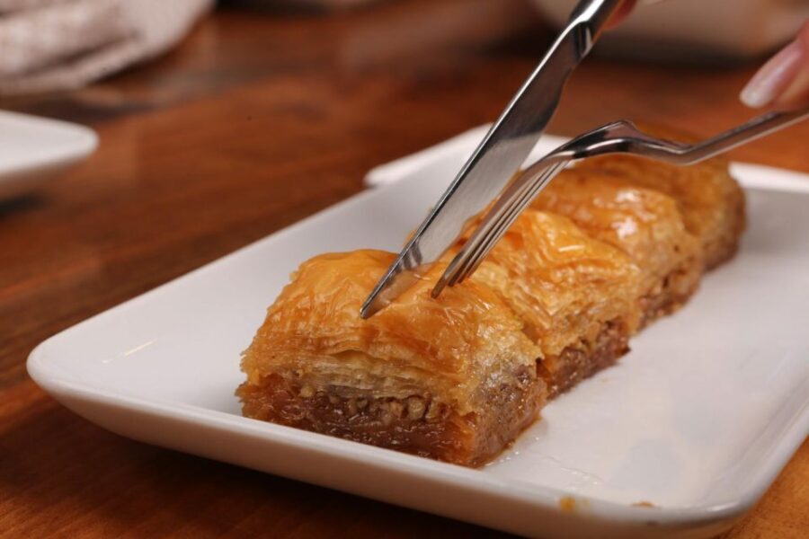 Athens: Street Food Tasting Tour - A shopping-district stroll with a boat-shaped pizza twist