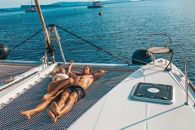 Half-Day Exclusive Catamaran Cruise in Santorini with Meal and Open Bar - Prosecco, wine, beer, and the social energy on a half-day catamaran