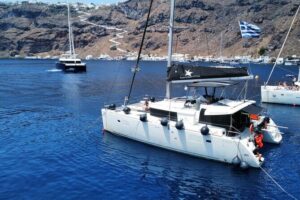 Half Day Premium Catamaran Cruise in Santorini including Oia - Red Beach: quick swim break at a stop that looks wild from the deck
