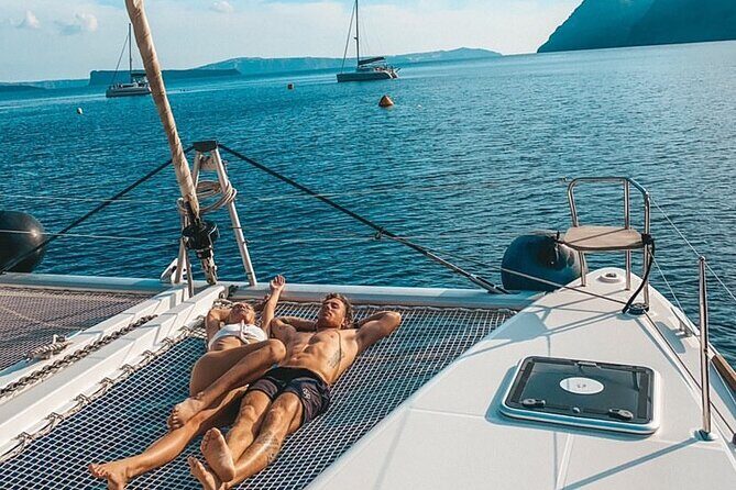 Half Day Premium Catamaran Cruise in Santorini including Oia - Oia from the water: Ammoudi Bay, port views, and the Venetian lighthouse
