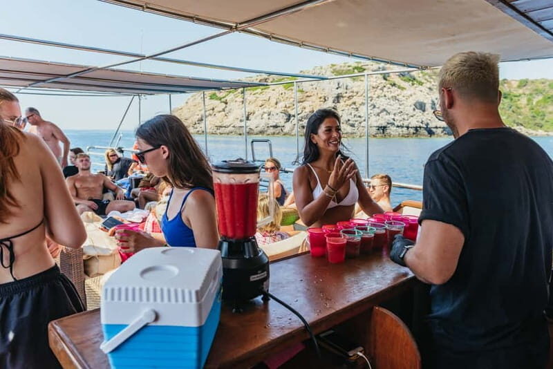Rhodes: Anthony Quinn, Ladiko and Caves All-Inclusive Cruise - Aphrodite catamaran comfort: sofas, shade, and a crew that keeps things moving
