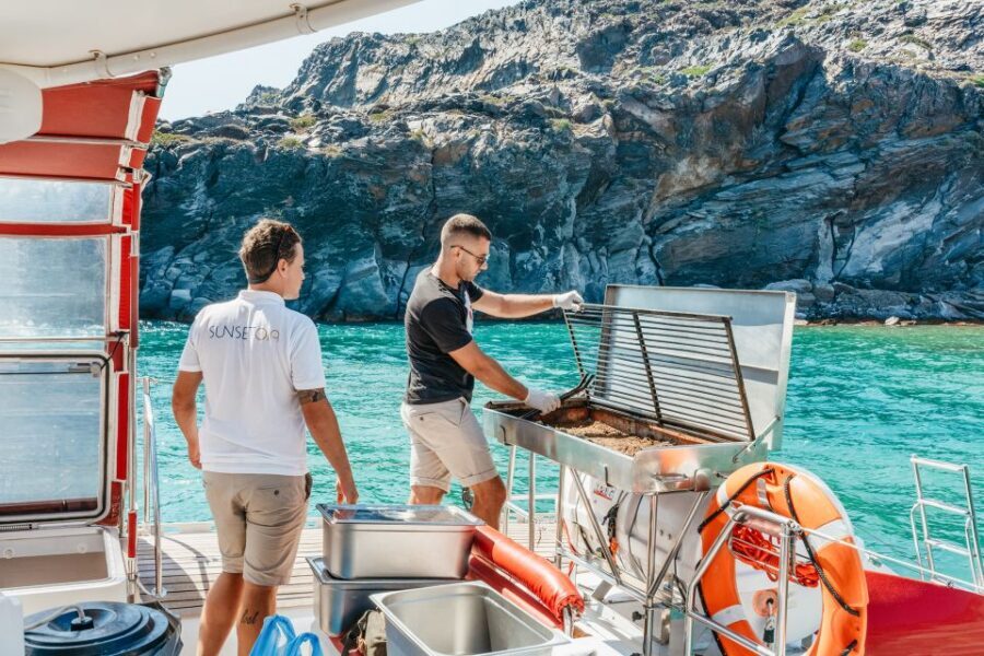 Santorini: Catamaran Tour with BBQ Dinner, Drinks, and Music - Red Beach swim and snorkeling: where the clock really matters
