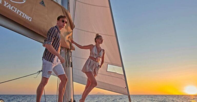Santorini Gold Catamaran Cruise with Snorkel, BBQ & Open Bar - White Beach views and the Venetian lighthouse from sea level