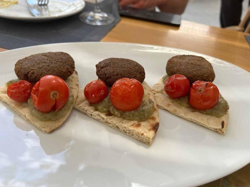 Santorini: Small-Group Sunset Wine Tour with Santo Winery - Food pairings: Greek cheese, tapas, and keeping the evening comfortable