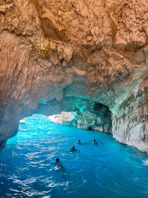 Zakynthos: Shipwreck Beach with Blue Caves Land & Sea Tour - Anafonitria and the glass-bottom boat: cave color from below